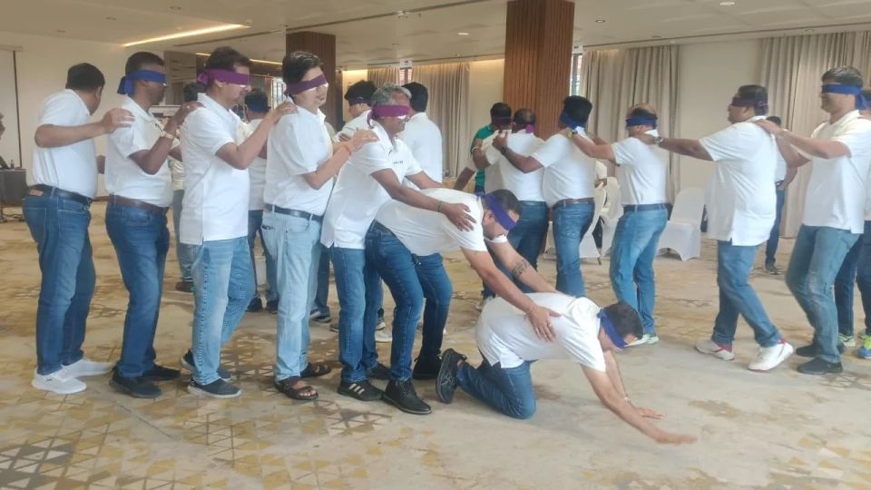 Blindfold trust and coordination exercise during a Catalyst corporate experiential workshop