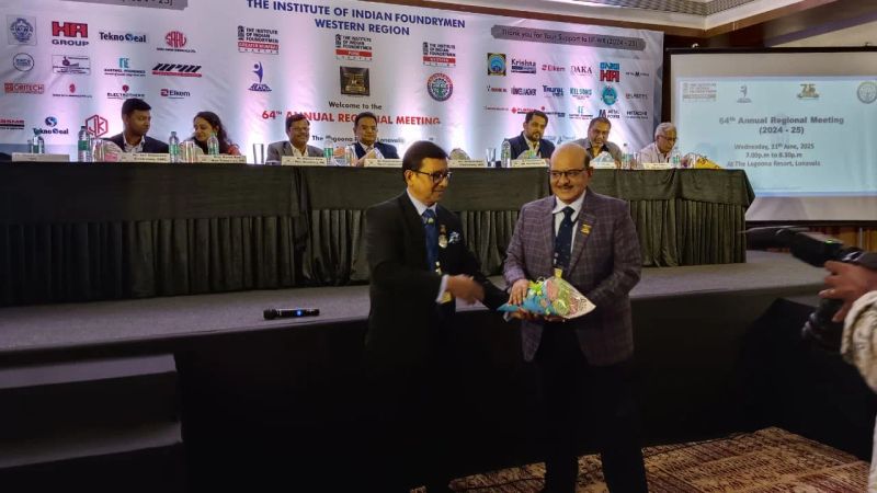 Felicitation ceremony on a branded stage at a formal corporate annual meeting